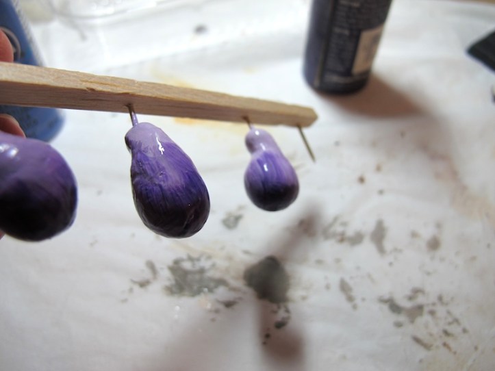 Painted in shades of purple. I will give it a matte coat when it is dry and rough up the surface a bit.